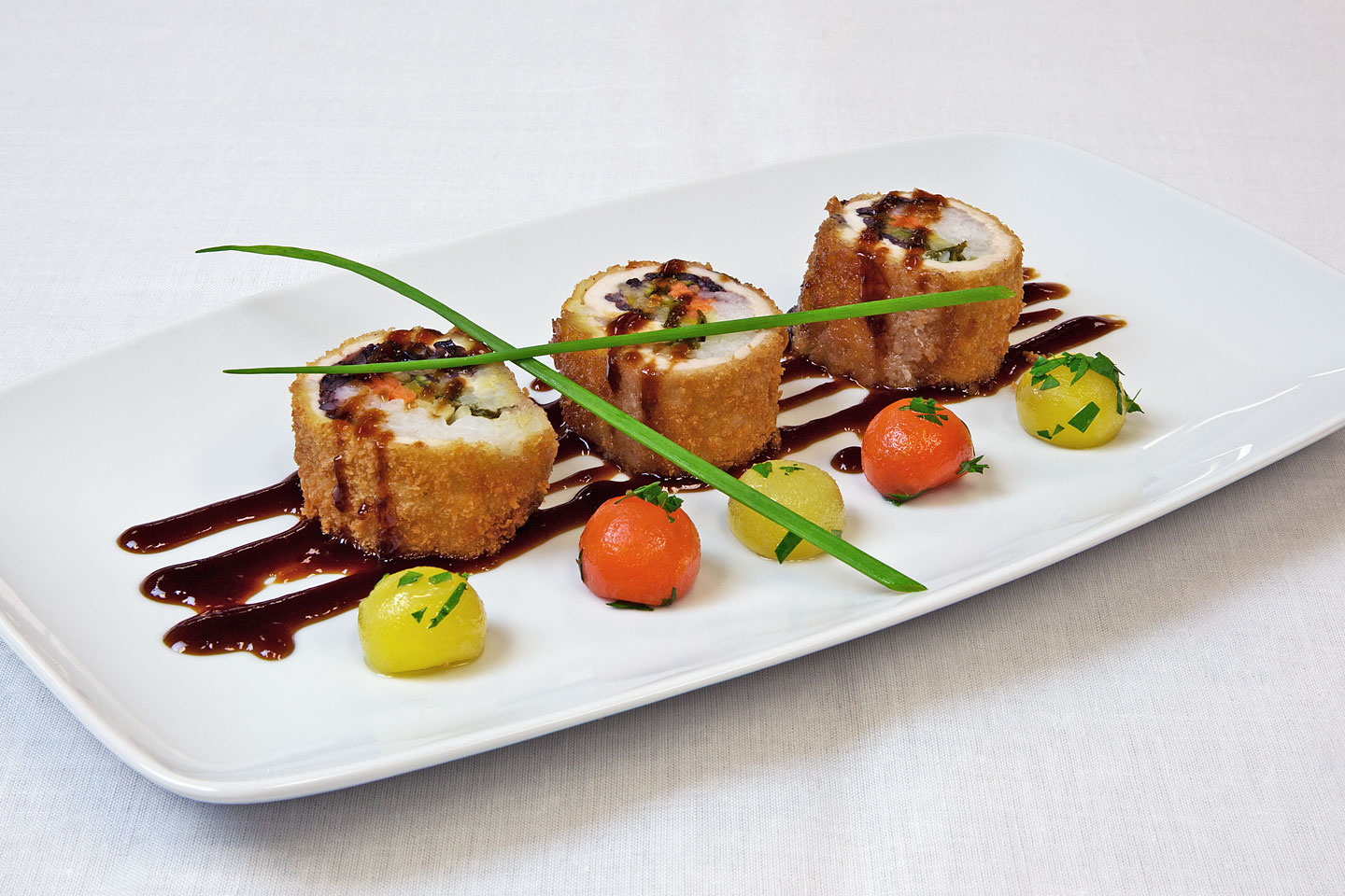 a delicious appetizer prepared by danziger kosher catering and served on a square oval porcelain plate
